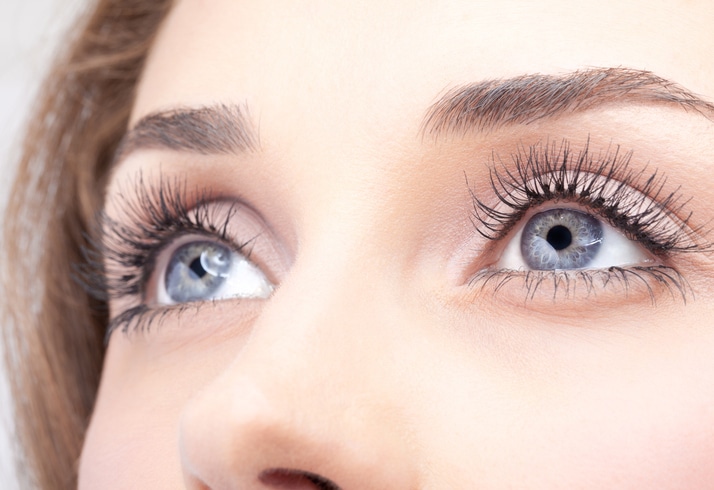 Close-up of woman's grey eyes with mascara
